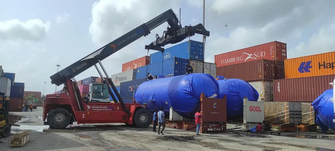 Reach stacker handling wrapped cargo in a container yard