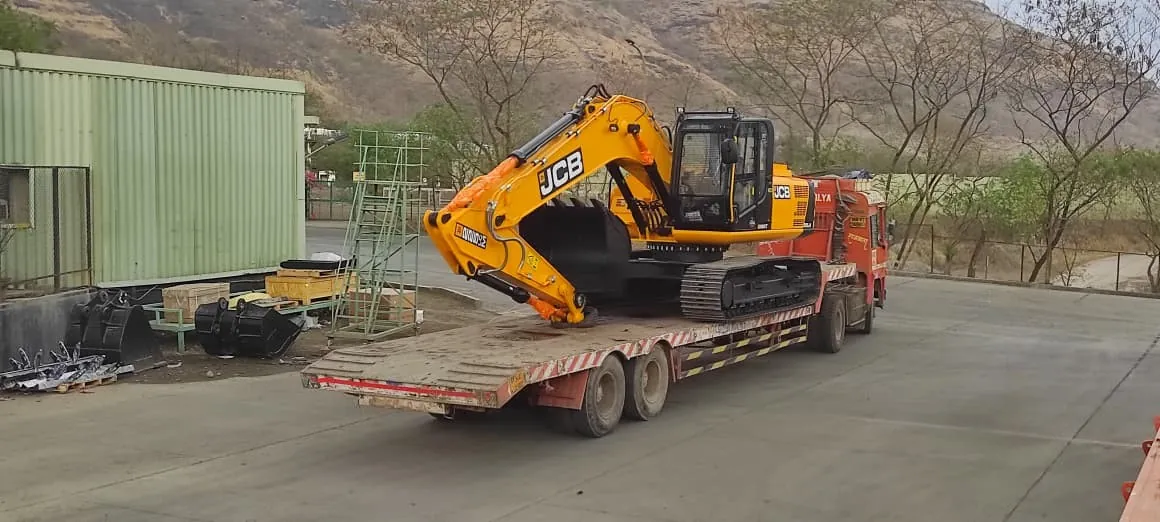 Excavator loaded on a low-bed trailer