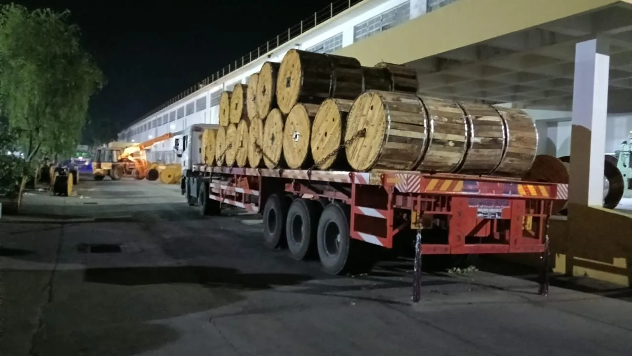 Cable drums loaded on a trailer at night