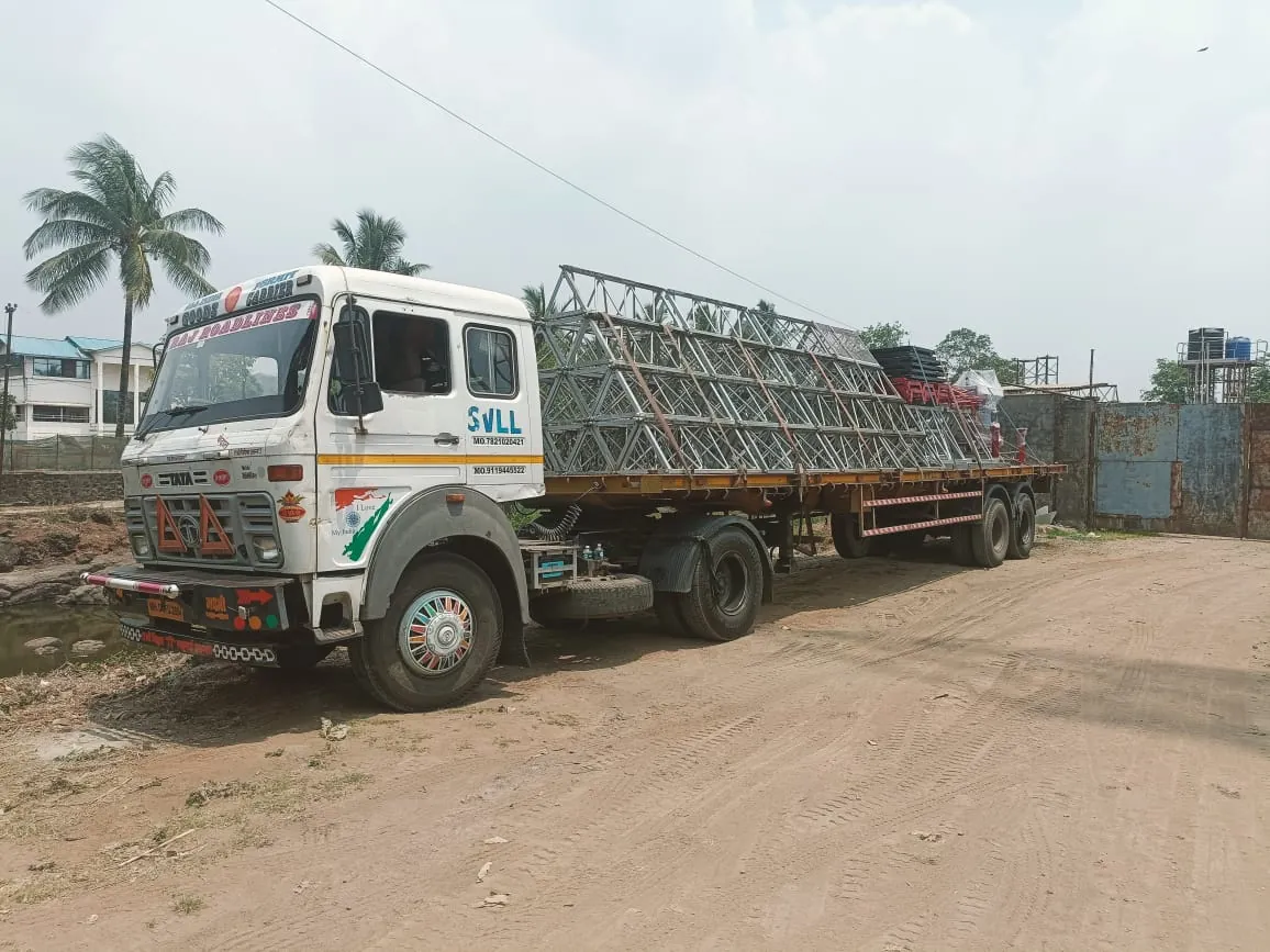 Truck carrying steel lattice structures on a flatbed trailer