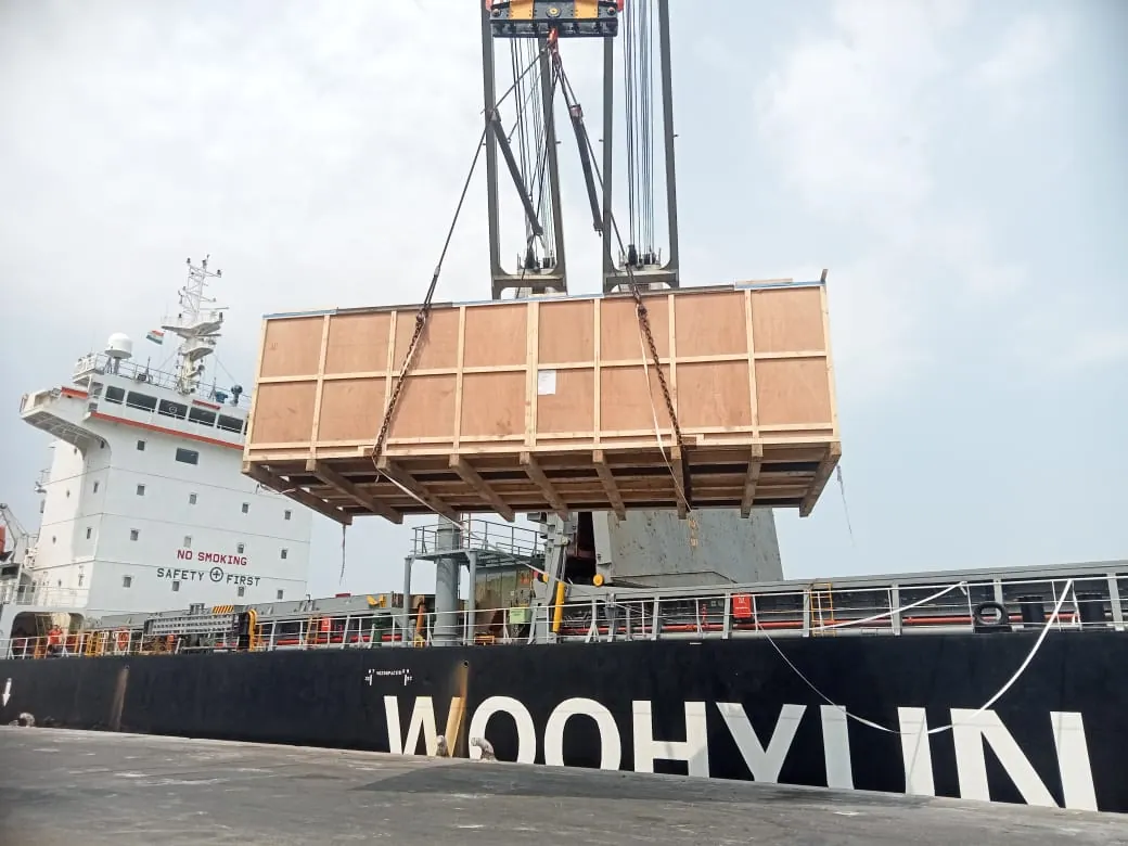 Wooden crate being lifted onto a vessel by crane